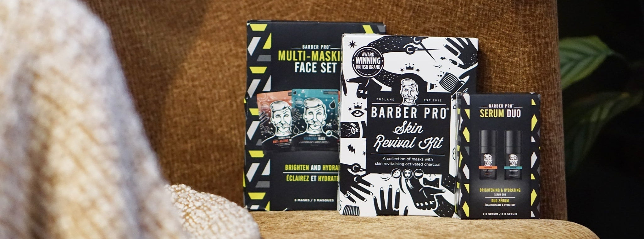 3 BARBER PRO gift sets on a chair with a blanket laid over it